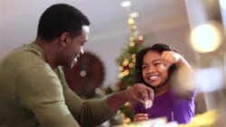 Happy father and daughter sprinkle flour on cookie dough Stock Footage