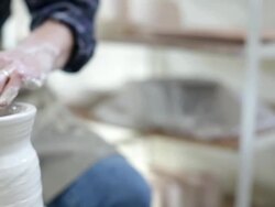Midsection of woman throwing clay on potters wheel Stock Footage