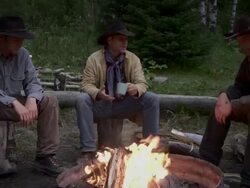Cowboys sit around fire Stock Footage