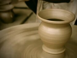 Potterâ€™s skilled hand taking the pot out of pottery wheel Stock Footage