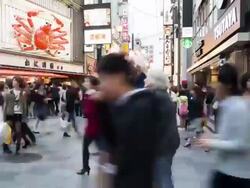 TL, WS Shoppers rush through Osaka centre past giant mechanical crab / Osaka, Japan Stock Footage