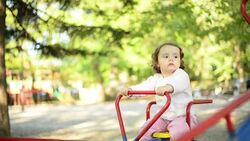 Girl playing on seesaw. Stock Footage
