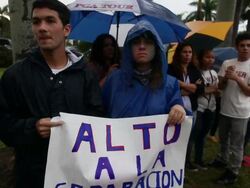 Mid shot of protesters holding banners, pan to left more protesters with  banners Immigration Activists Protest Outside Of Marco Rubio Fundraiser at Biltmore Hotel on April 05, 2013 in Miami, Florida (Footage by Getty Images)Immigration Activists Protest O Stock Footage