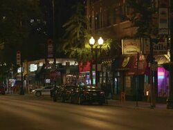 WS Street lined with shops night Stock Footage