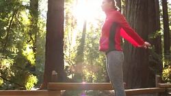 A young women running, working out, stretching and checking her mobile device outdoors on a sunny day. Stock Footage