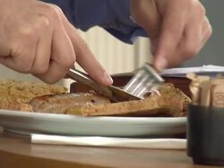 anonymous man eating fried breakfast in cafe News Clip
