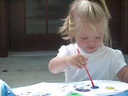 Little girl paints with the color blue. Stock Footage
