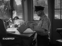 1952: CAPTAIN BILL CUNNINGHAM: VS Diesel powered towboat captain Bill Cunningham of the Shannopin steering ship from pilot house, checking map, driving along the Monongahela River (the Mon). Instructional Video