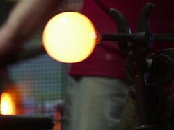 Glass Blower Forming Hot Glass In A Big Wood Block Stock Footage