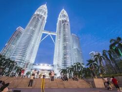 WS LA T/L Petronas Towers at dusk with tourists / Kuala Lumpur, Selangor, Malaysia Stock Footage