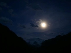 Evening view of full moon and surrounding mountains Stock Footage