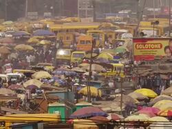 MS City market with lots of Coloured umbrellas and publicity panels / Lagos, Nigeria Stock Footage