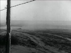 B/W 1936 wind blowing dust over dusty plain in storm / barbed wire fence in foreground / Dust Bowl Stock Footage