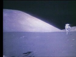 Wide shot of astronaut Eugene Cernan running toward camera on Moon Stock Footage