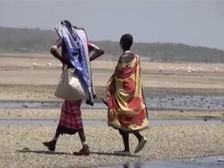 MS TS Two masai woman walking through dessert around lake magadii AUDIO / Magadi, Rift Valley, Kenya   Stock Footage