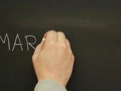 Writing 'Marketing' on the school blackboard Stock Footage