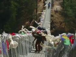 MS Shot of people walking across suspension bridge at Larjha Doban remote Mt Everest / SoluKhumbu, Nepal Stock Footage