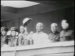 B/W 1950s Ho Chi Minh raising hat surrounded by others on balcony / North Vietnam / newsreel Stock Footage