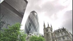 A skyscraper, The Gherkin, and a building with spires occupy a neighborhood. Stock Footage