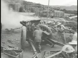 1946: FIRST INDOCHINA WAR: VS French Army artillery regiment firing artillery cannons, explosions in the distance, straw house burning on fire. VS Large group of Communist Chinese prisoners of war walking w/ hands on their heads. POW Instructional Video
