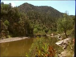 Channel and vegetated slopes of River Yeguas, Sierra Morena, Andalucia, Southern Spain Stock Footage
