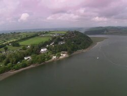Dylan Thomas Boat House on shore of estuary Stock Footage