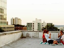 Friends toasting wine glasses on rooftop Stock Footage