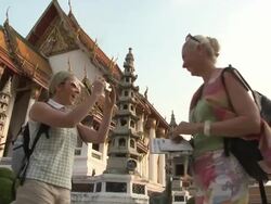 MS LA Woman photographing friend at Wat Phra Kaew (Temple of the Emerald Buddha), Bangkok, Thailand Stock Footage