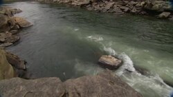 A river washes over boulders. Stock Footage