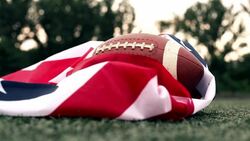 Training with an American flag and a rugby ball Stock Footage