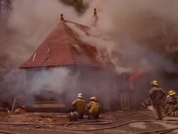 MS ZO Firemen working on burning rural information booth / Unspecified Stock Footage