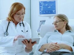 Doctor advising patient with the help of tablet Stock Footage