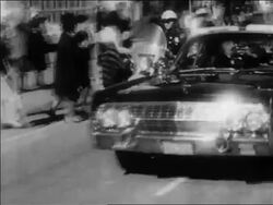 B/W 1963 PAN John + Jacqueline Kennedy riding in convertible in motorcade / Dallas / newsreel Stock Footage