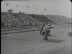 A car drives up a small ramp and flips over at a stunt show. News Clip