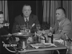 1952: NEW ORLEANS: FRENCH QUARTER: LA MS International House Director Charles Nutter at restaurant table w/ manufacturer's representative Mr. Porto w/ headwaiter cooking Crepes Suzette tableside FG, pan flaming, serving crepes onto plates, to table. Instructional Video