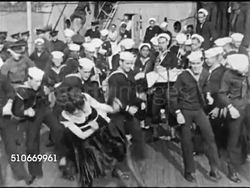 1921: DANCE DEMONSTRATION: WS US Navy battleship moored in harbor, HA TD WS Female dancer dancing 'Black Bottom' dance w/ U.S. Sailors on deck, MS Sailor's legs dancing dance steps next to dancer's legs in dark hose & skirt well above knee. Instructional Video