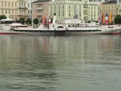 TU swan, paddle steamer 'Gisela' and historic center of Gmunden Stock Footage