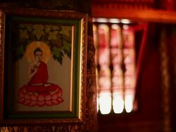 MS Shot of Buddhist frame hanging on wall / Luang Prabang, Laos Stock Footage