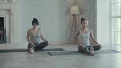 Two women doing yoga meditation and stretching exercises Stock Footage