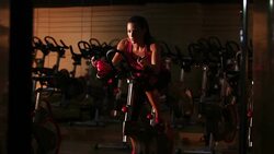 Female exercising on a bike Stock Footage