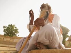 Low angle view of a sage worshipping, Jaisalmer, Rajasthan, India Stock Footage
