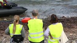 Syrian migrants fleeing the war and escaping to Europe, landing on the Greek island of Lesvos on the north coast at Efthalou and helped ashore by volunteers. Up to 4,000 migrants a day are landing on the island and overwhelming the authorities. They are tr Stock Footage