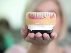 Dentist holding dentures Stock Footage