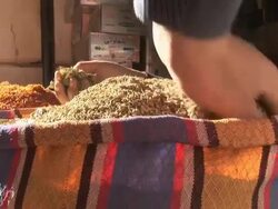 Medium Close Up, hand-held zoom-out - A vendor folds down the edges of produce bags / Egypt Stock Footage
