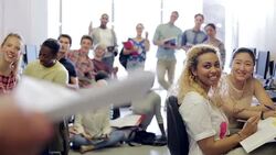 Teacher talking to smiling students in computer class Stock Footage