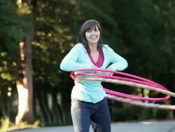 MS TD TU Young woman hula hooping on country street / Richmond, Virginia, United States Stock Footage