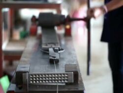 Goldsmith Jeweler rolled silver metal Stock Footage