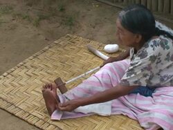 Senior woman spinning, village of Mapajo inhabited by the tribe of Mosetenes, Bolivia, Amazon Stock Footage