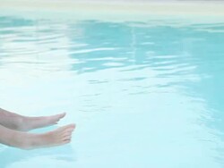 Relaxing in a swimming pool floating on an air bed Stock Footage