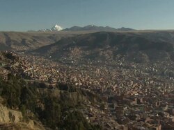 Overview of La Paz [Nuestra SeÃƒÂ±ora de La Paz/Chuquiago Marka/Chuqiyapu] with mountains and glacier in b/g, Bolivia Stock Footage
